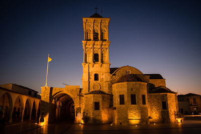 Low angle view of illuminated building against sky at night