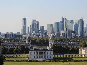 Modern buildings in city against clear sky