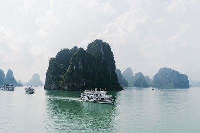 Panoramic view of boats sailing in sea against sky