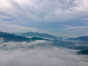 Scenic view of mountains against cloudy sky