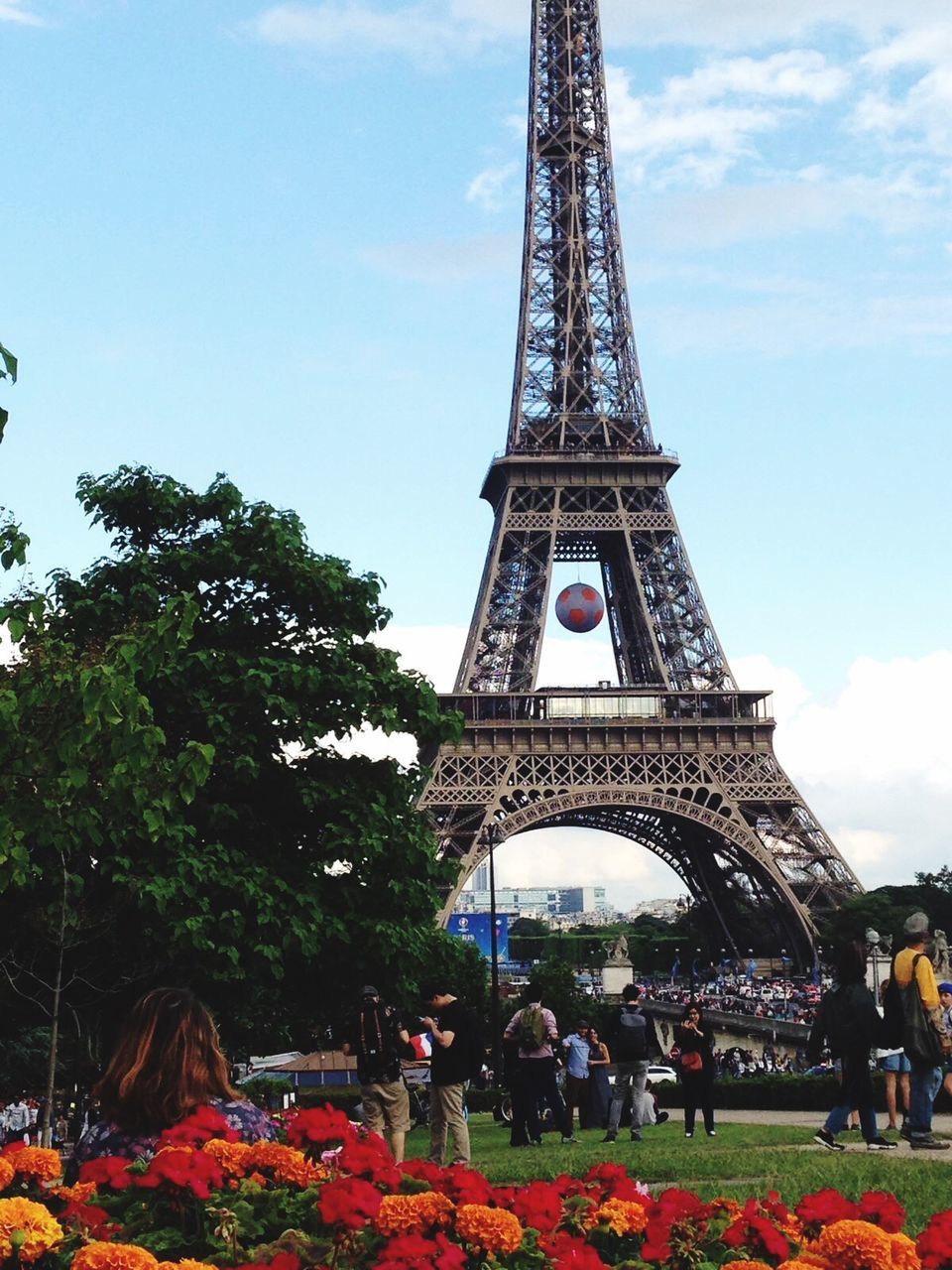 eiffel tower, architecture, built structure, famous place, tourism, tree, travel destinations, sky, large group of people, international landmark, capital cities, travel, culture, tower, leisure activity, tall - high, metal, person, tourist