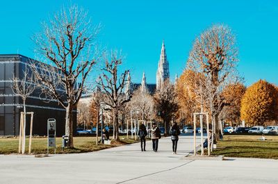 Panoramic view of trees and buildings against blue sky