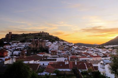 Aerial view of town against sky during sunset