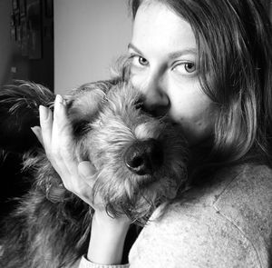 Portrait of woman with dog at home