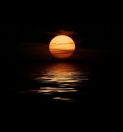 Sun shining through clouds over sea