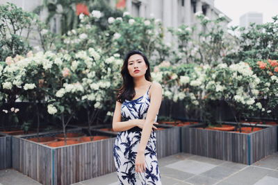 Portrait of beautiful young woman standing outdoors