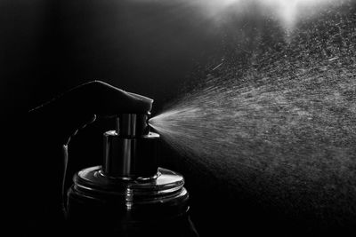 Close-up of wine bottles against black background