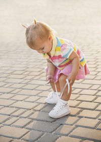 Full length of boy standing on footpath