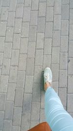 Low section of woman on tiled floor