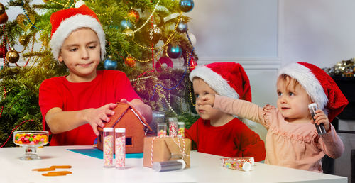 Mother playing with christmas tree at home