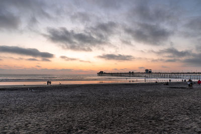 Scenic view of beach against sky during sunset