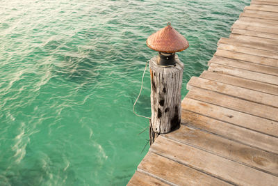 Lamp on wooden pier by lake