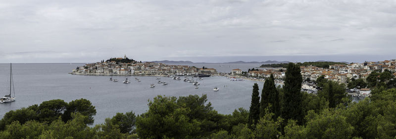 Panoramic view of sea and buildings against sky