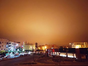 High angle view of illuminated buildings against sky at night