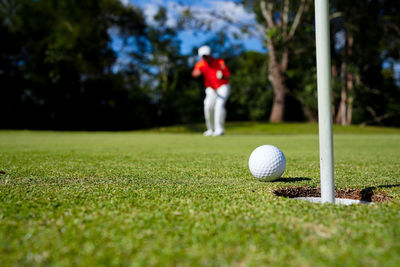 Low section of man playing golf on field