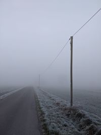 Scenic view of road against sky during winter