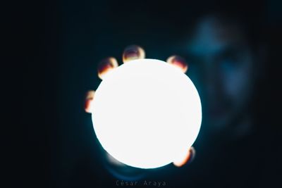 Close-up of illuminated lamp against black background