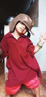 Full length of woman with hat standing outdoors