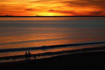 Scenic view of sea against orange sky