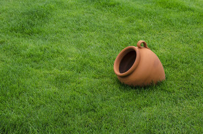 High angle view of brown pot on grass