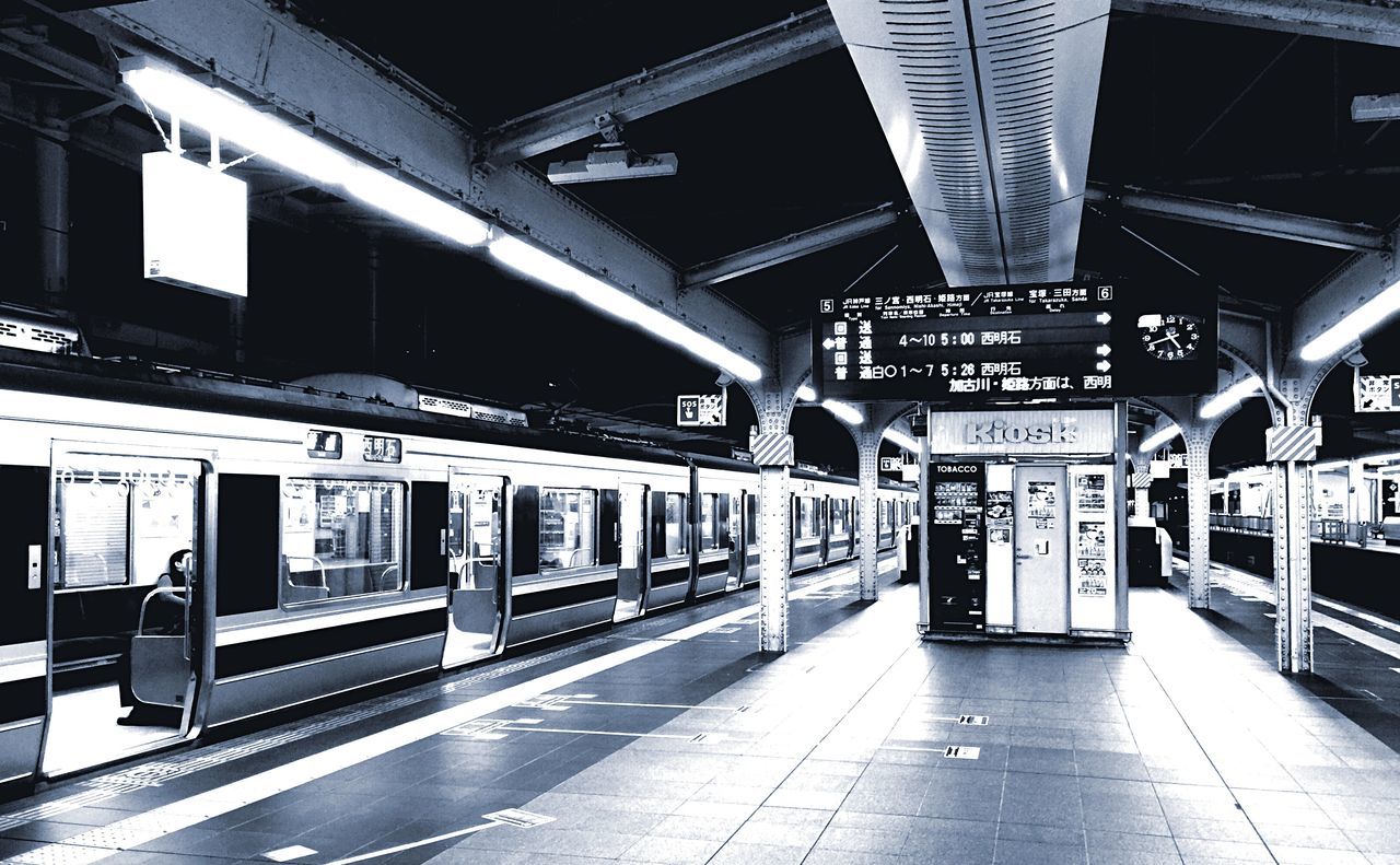 architecture, built structure, transportation, illuminated, railroad station, public transportation, railroad station platform, indoors, text, empty, the way forward, incidental people, city, building exterior, subway station, rail transportation, western script, communication, ceiling, travel