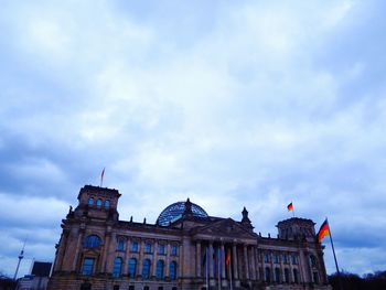 Low angle view of building against cloudy sky