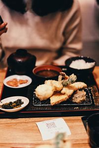 Cropped hand of woman having food