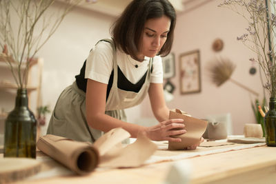 Woman working on table at home