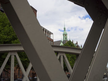 Buildings in city against cloudy sky