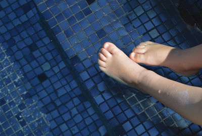 Low section of child in swimming pool