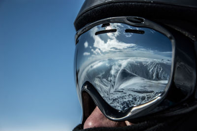Reflection of mountains on ski goggles