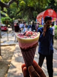 Midsection of woman holding ice cream cone