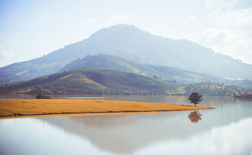 Scenic view of lake and mountains against sky