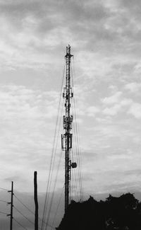 Low angle view of silhouette electricity pylon against sky