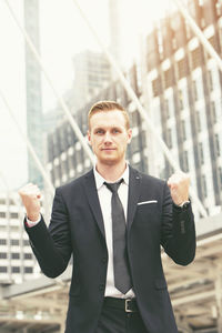 Young man standing in front of office building