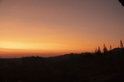 Scenic view of silhouette landscape against romantic sky at sunset