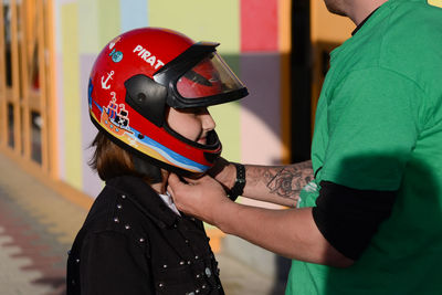 Midsection of man holding helmet