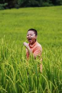 Happy young woman in field