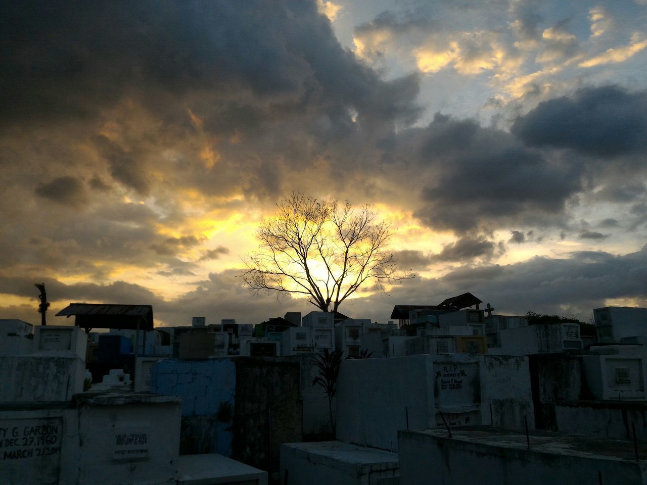 SILHOUETTE HOUSES AGAINST SKY DURING SUNSET