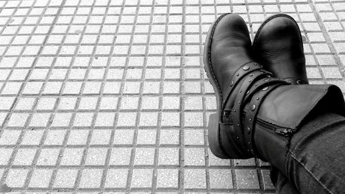 Low section of person standing on tiled floor