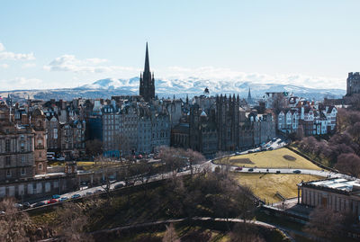 Aerial view of buildings in city against sky