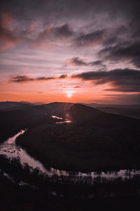 Scenic view of mountains against dramatic sky during sunset