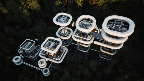 Aerial view of factory by trees in forest