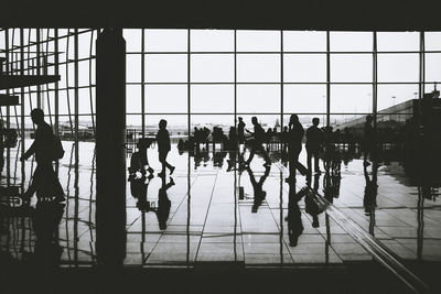 Group of people walking on glass window