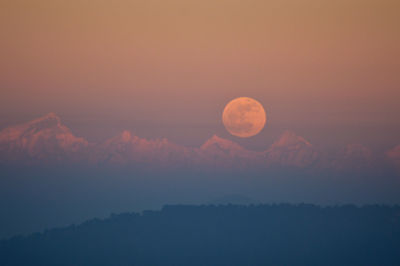 Scenic view of moon against sky at sunset