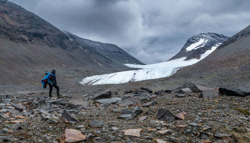 Rear view of man walking on mountain