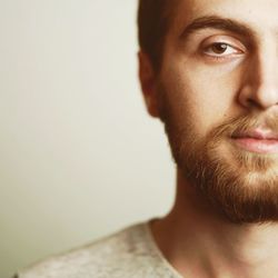 Close-up portrait of young man against white background