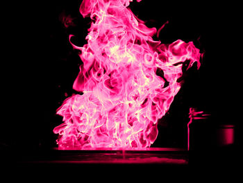 Close-up of pink water splashing against black background