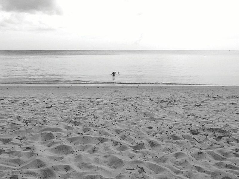 SCENIC VIEW OF CALM BEACH AGAINST SKY