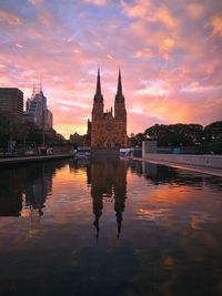 Reflection of building in lake during sunset